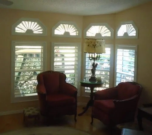 Custom shutters fitted to fan-top and specialty-shaped windows in a Ponte Vedra home